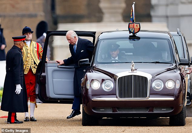 King Charles III is greeted by Sir Kenneth Olisa, Lord-Lieutenant of Greater London as he arrives, in his chauffeur driven Bentley State Limousine