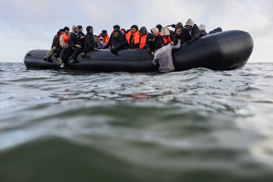 Migrants in a small boat attempting to cross the English Channel.