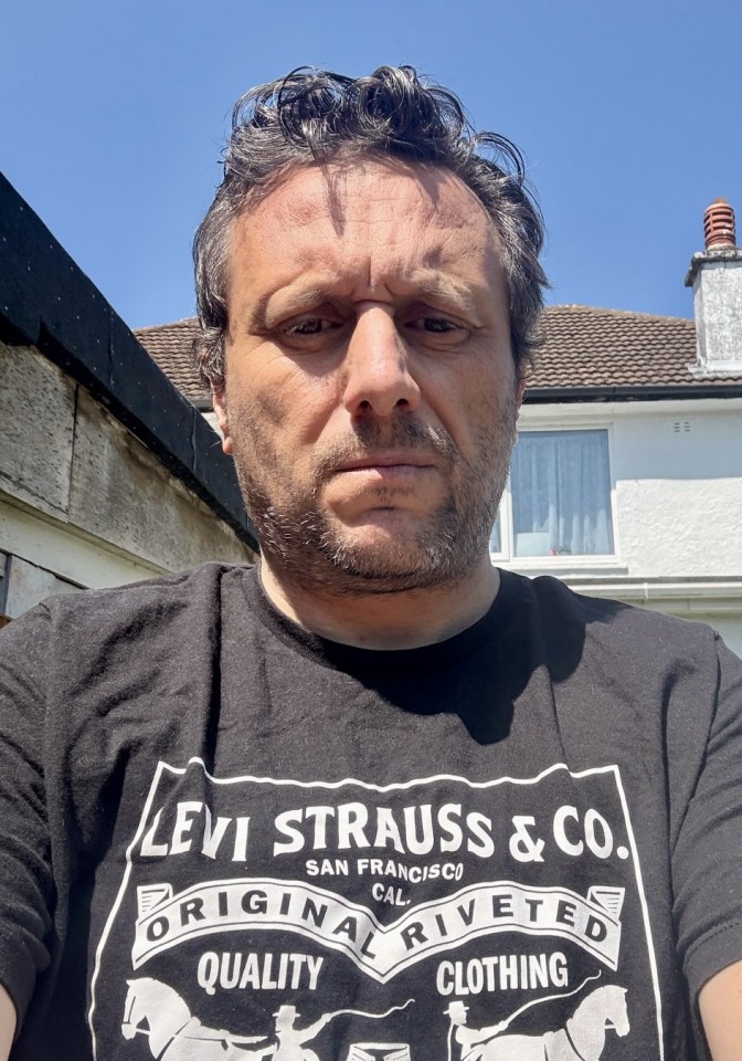 Close-up of a man wearing a Levi Strauss & Co. t-shirt.