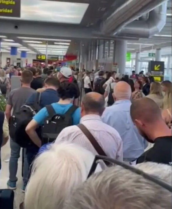 Long lines of people at an airport security checkpoint.