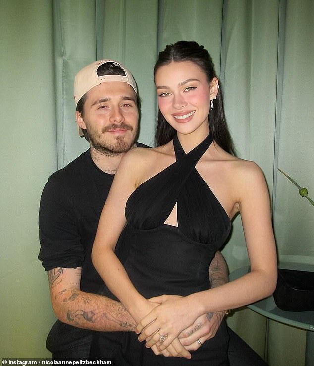 Nicola Peltz is pictured beaming as she poses for a picture with her husband Brooklyn Beckham