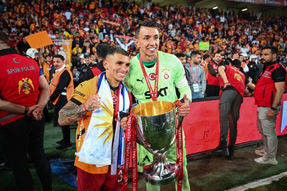 GAZIANTEP, TURKIYE - MAY 14: Lucas Torreira and Fernando Muslera pose with the trophy as Galatasaray players celebrate after a 3-0 victory over Trabzonspor in the Ziraat Turkish Cup Final at Gaziantep Metropolitan Municipality Stadium in Gaziantep, Turkiye, on May 14, 2025. With the win, Galatasaray secures the Turkish Cup for the 19th time. (Photo by Akin Celiktas/Anadolu via Getty Images)