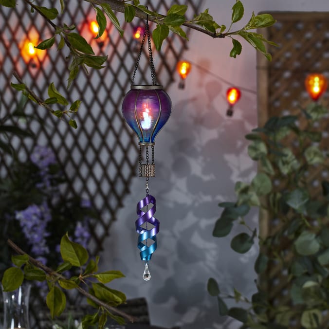 Solar-powered hot air balloon light with spiral accent.