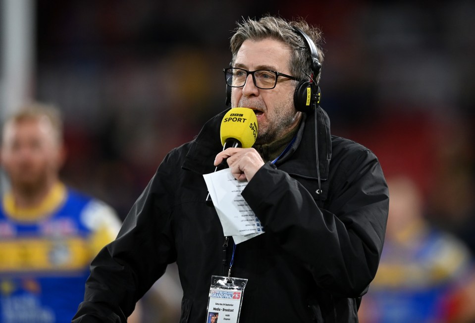 BBC radio presenter Mark Chapman speaking into a microphone.