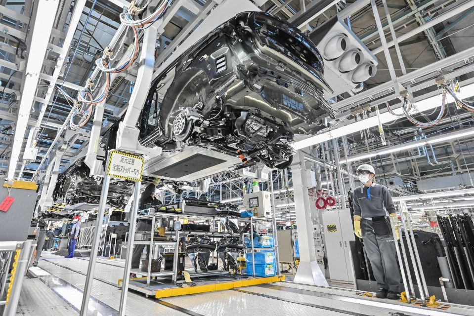 A car in a Nissan factory on an assembly line.