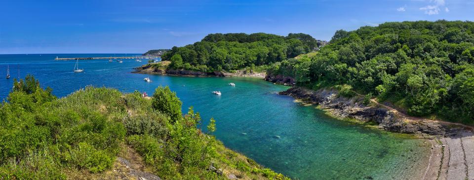 Fishcombe Cove in Brixham, Devon, with Brixham Breakwater Lighthouse in the distance.