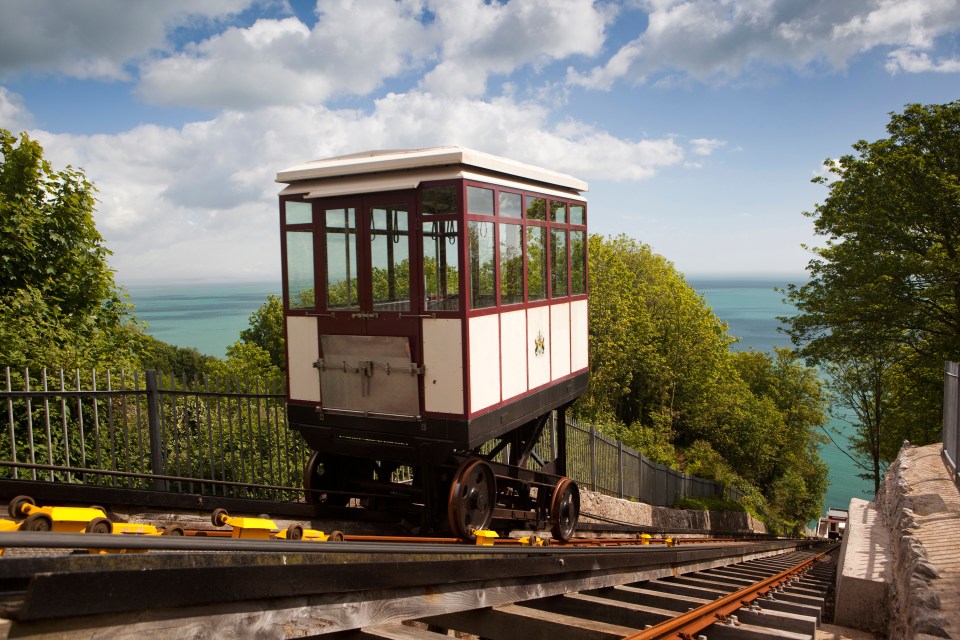 Funicular railway car descending toward the ocean.