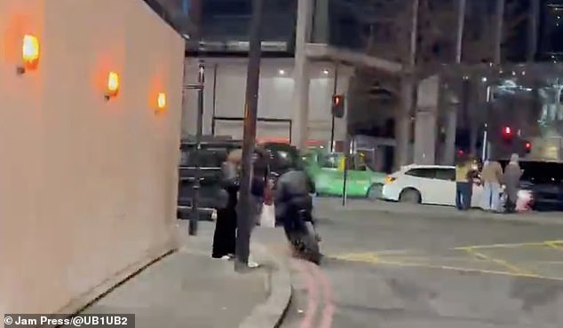 The two riders targeted the man who was carrying a white bag and casually standing by the kerb with a woman