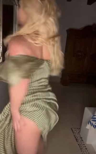 Britney Spears dancing in a green dress.