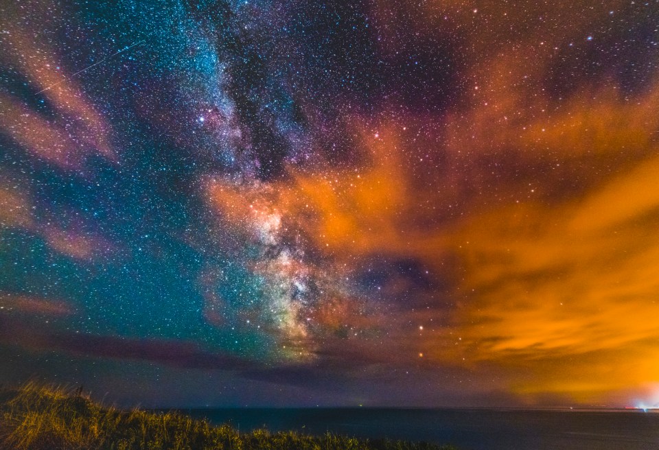 Milky Way galaxy over the ocean at night.