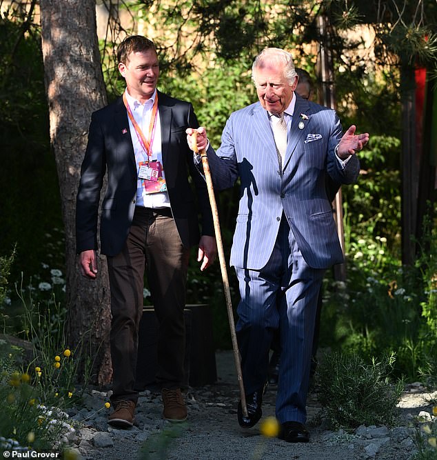 Charles appeared as regal as ever in a blue pinstripe suit as he stepped out at the flower show this evening