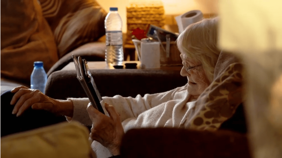 Elderly woman using a tablet.