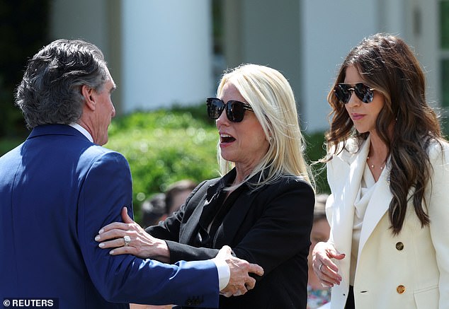Attorney General Pam Bondi (center) greets Interior Secretary Doug Burgum (left) as Department of Homeland Security Secretary Kristi Noem (right) looks for her seat at the Rose Garden ceremony