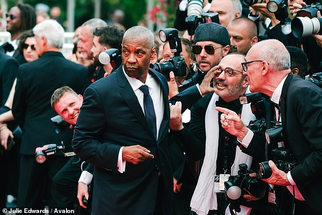 An irate Washington then flung the photographer's hand away and shouted 'Stop it, stop it stop it!' before walking off