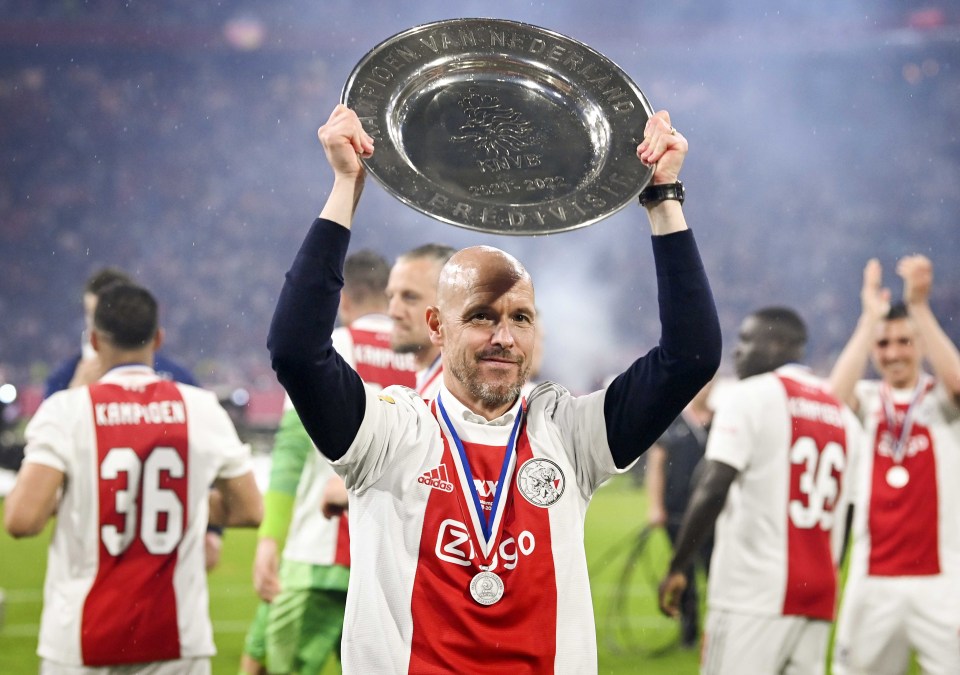 Erik ten Hag holding the Eredivisie trophy aloft.