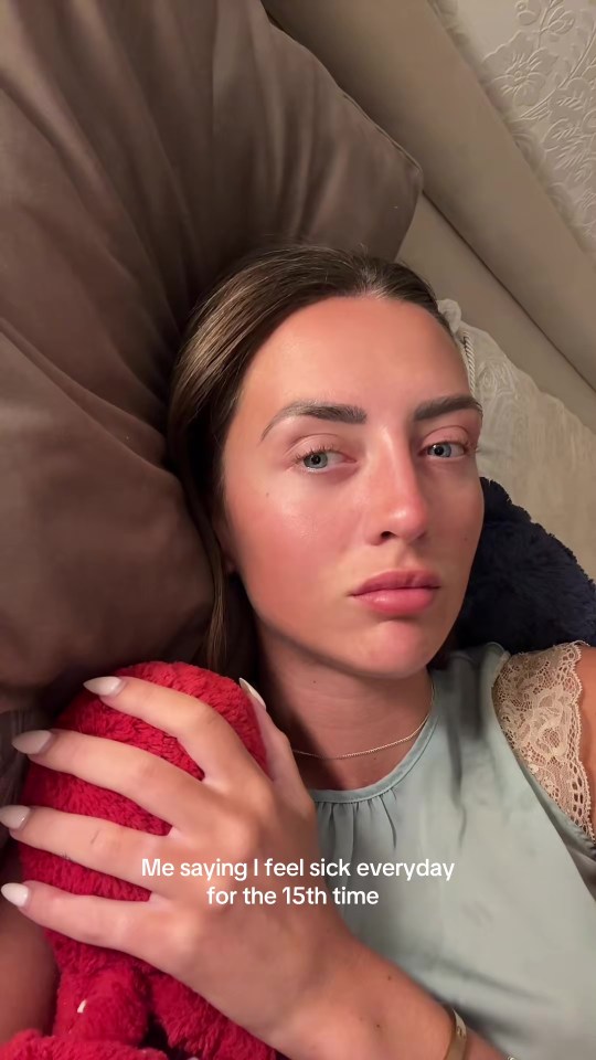 Woman in bed holding a stuffed animal, caption says "Me saying I feel sick everyday for the 15th time"