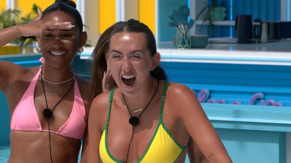 Two women in bikinis reacting excitedly.