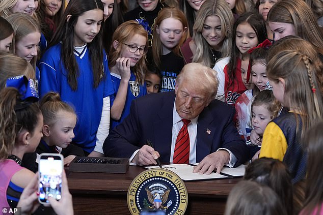 The latest moment involving transgender women in female sports comes as President Donald Trump's bill to ban that from happening fell into the senate earlier this month. (Pictured: Trump signing an executive order in February barring transgender female athletes from competing in women's or girls' sporting events)