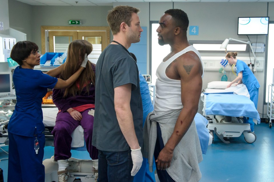 Scene from Casualty showing several characters in a hospital room.