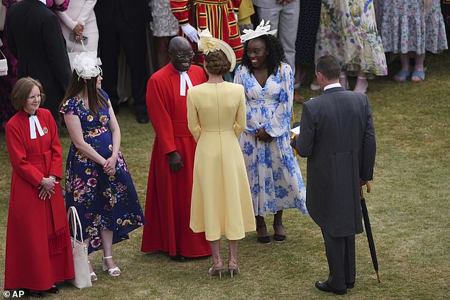 Britain's Kate, the Princess of Wales, speaks to guests as she attends The King's Garden Party