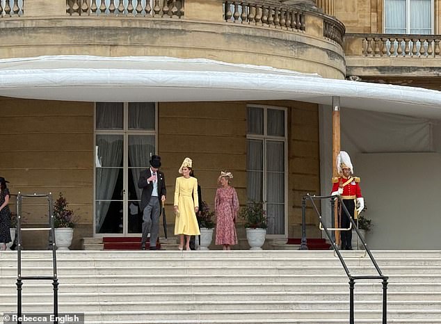 Kate, 43, donned a yellow dress by Emilia Wickstead and a hat by Phillip Treacy as she stood on the terrace for the National Anthem