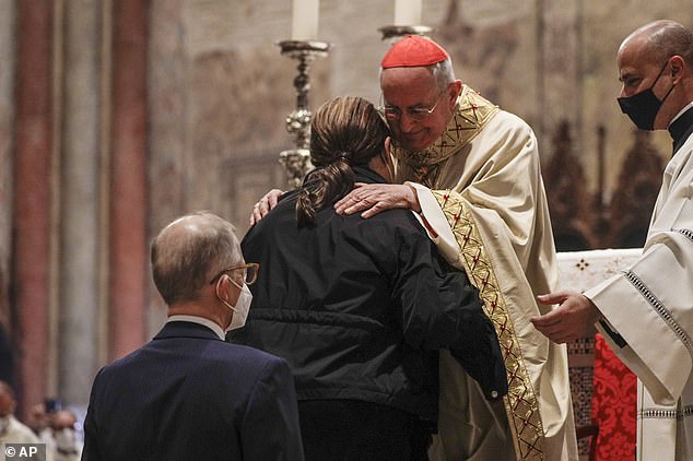 Acutis's parents, Antonia (front) and Andrea (rear) are greeted by Cardinal Agostino Vallini during the beatification ceremony in Assisi, central Italy, in October 2020
