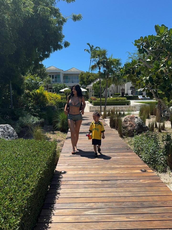 Woman and child walking on a boardwalk.