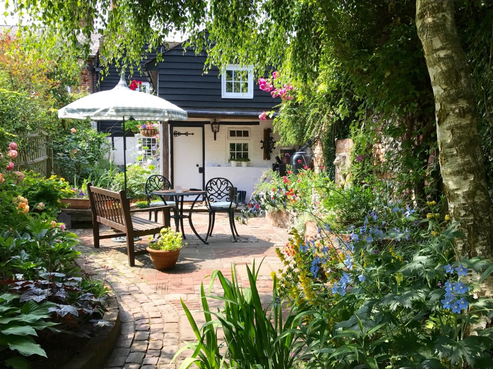 English cottage garden with patio furniture.