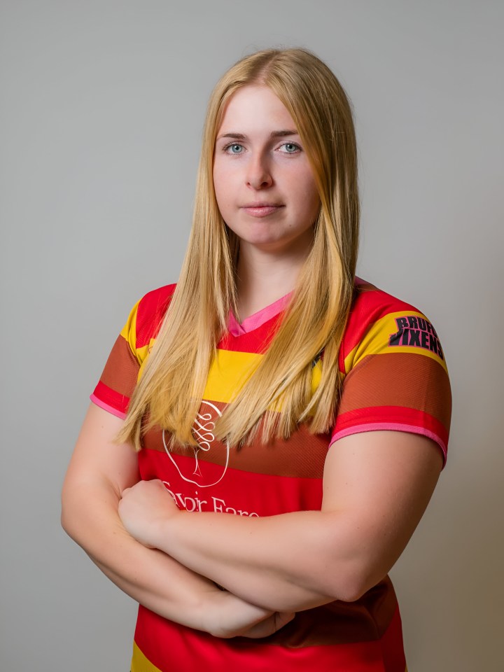 Portrait of Jennie Logan, a firefighter, wearing a rugby shirt.