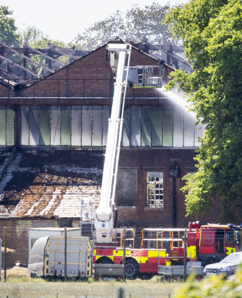 Firefighters extinguishing a fire at a brick building.