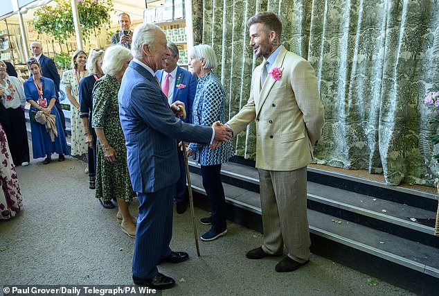 While Brooklyn was taking part in the photoshoot, his father David was just half a mile up the road at the Chelsea Flower Show chatting to King Charles and Queen Camilla