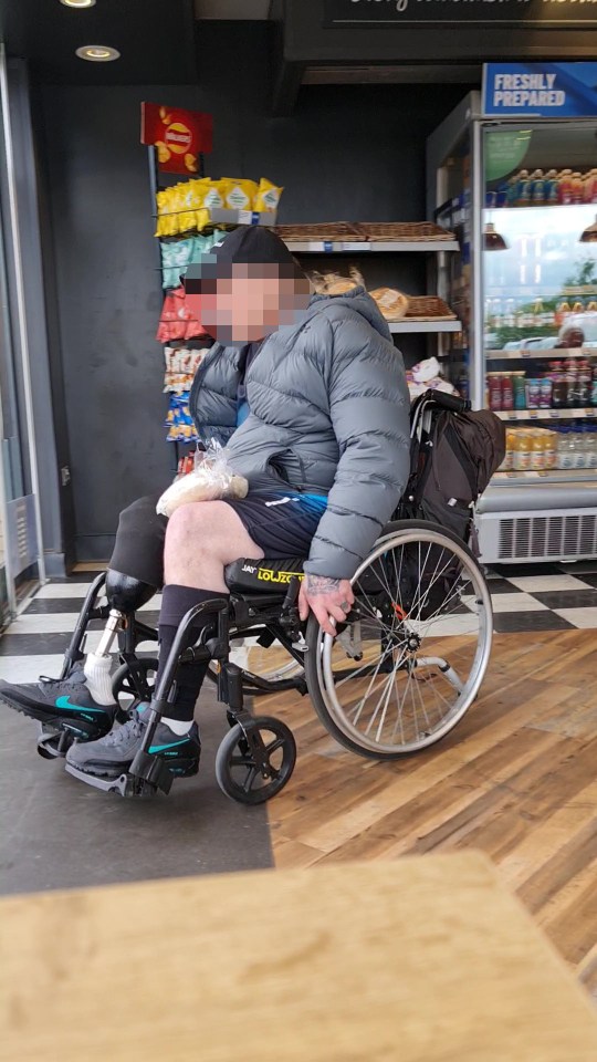 Footage of a person in a wheelchair inside a Greggs store.