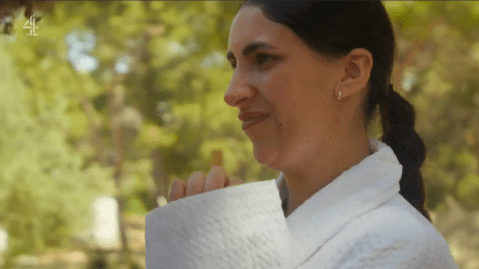 Woman in white robe outdoors.