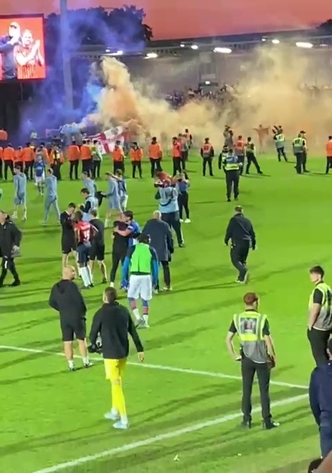 Oldham fans pitch invasion after reaching the playoff final.