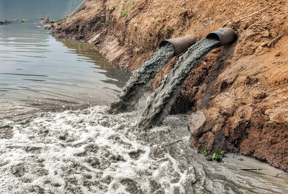 Industrial wastewater being discharged into a river.