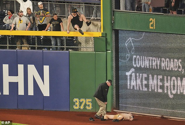 Markwood was seen laying down on the warning track before another fan leapt down to them