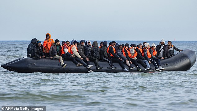 It is said to have crossed the Channel in a dingy packed with migrants, in what is believed to have be the first case of its kind. Pictured: Migrants off the coast of France in March