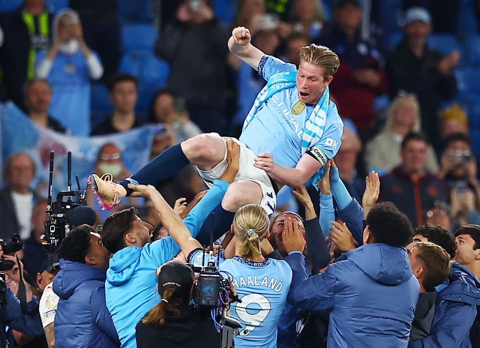 Kevin De Bruyne of Manchester City being hoisted in the air by his teammates after a match.
