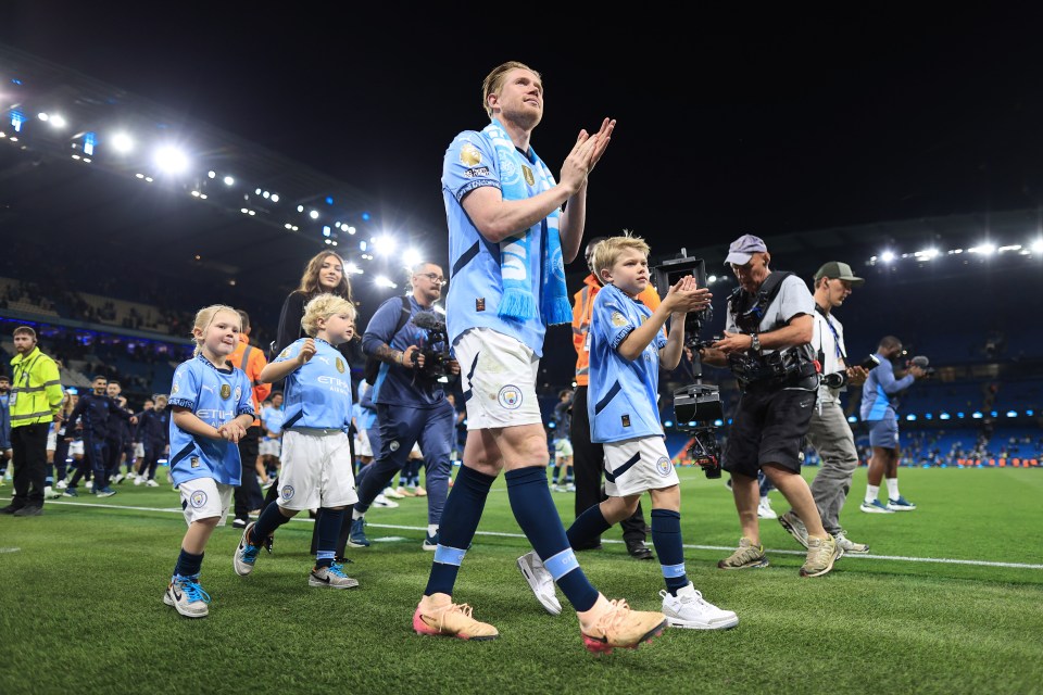 Kevin De Bruyne of Manchester City applauds with his family after a Premier League match.