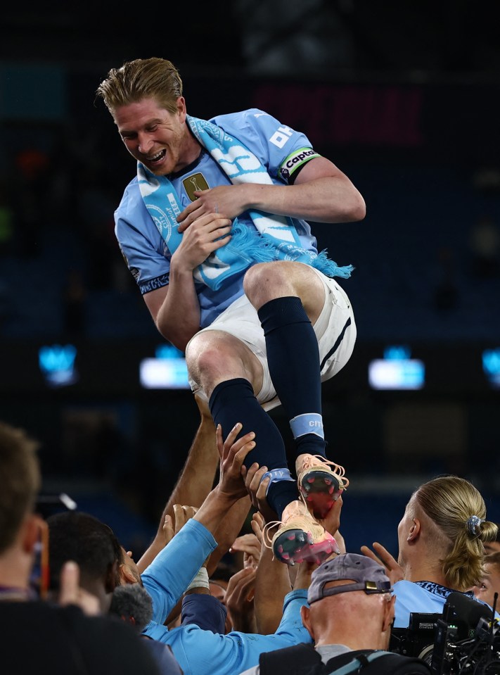 Manchester City's Kevin De Bruyne being hoisted by teammates after a match.