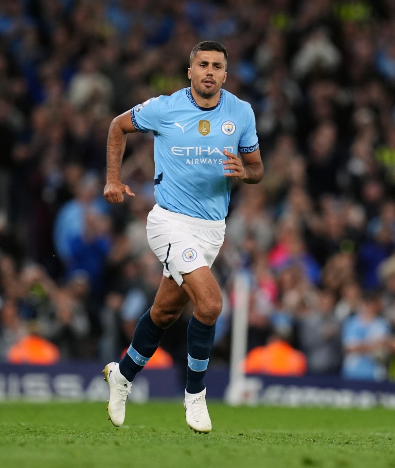 Rodri of Manchester City running on the pitch during a Premier League match.