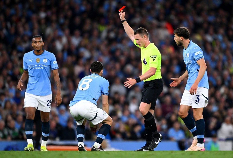 Referee showing a red card to a Manchester City player.