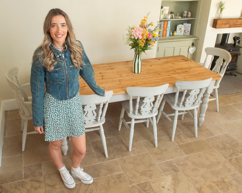 Woman standing by a farmhouse table.