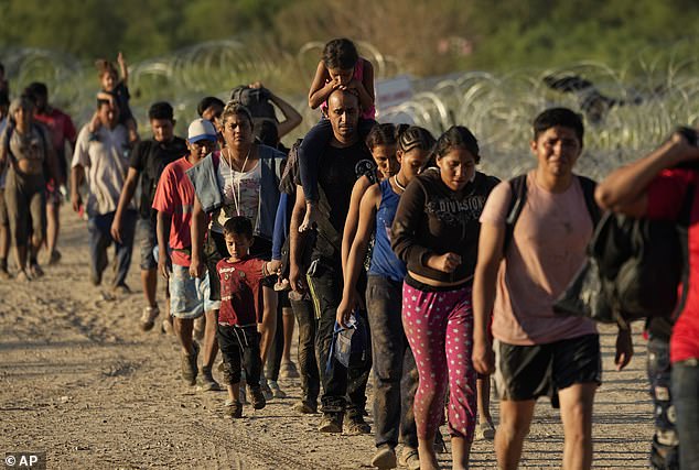 Throughout the campaign, particularly before Biden dropped out of the race, Trump would refer to the crisis as 'Biden's invasion' (Pictured: border crossers in 2023)