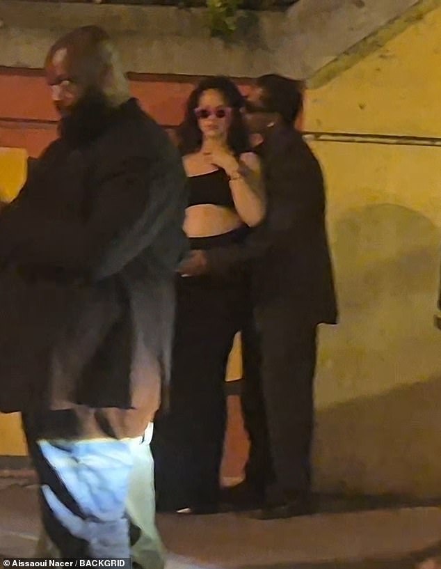 Rihanna pulled on a pair of bold pink sunglasses as A$AP sweetly kissed her cheek