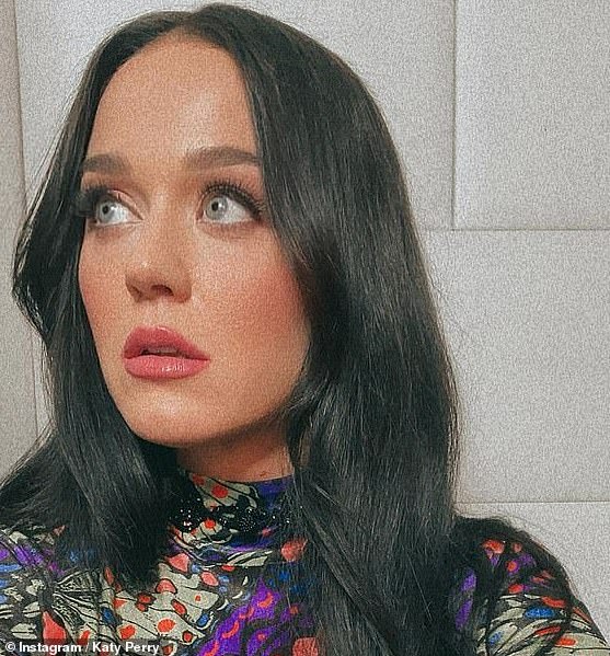 Katy Perry Katy was interviewed by Jimmy Kimmel wearing her black hair and joked that 'everything is fake' after revealing she was, again, wearing wig which was tucked behind her blonde strands