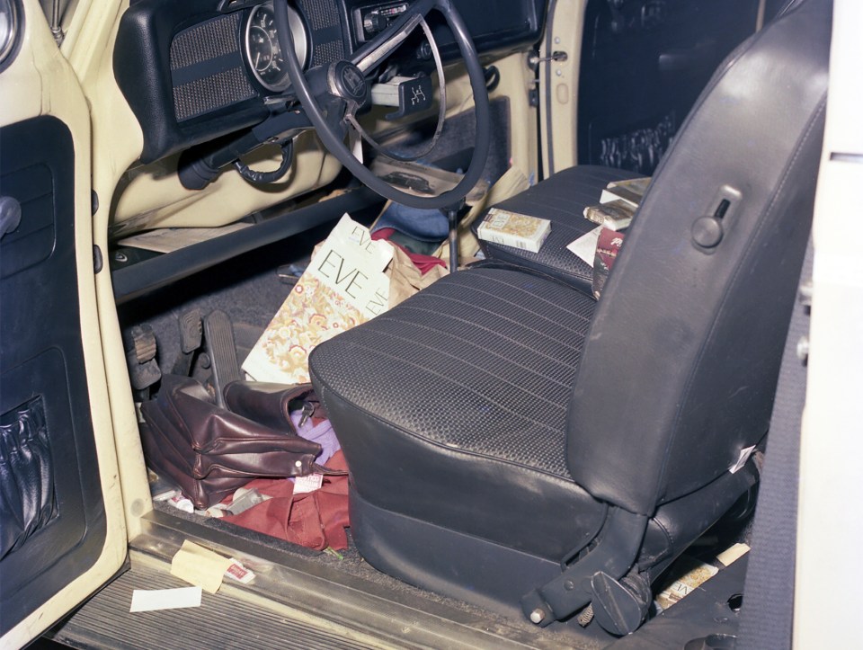 Interior of a Volkswagen with various items including a pack of Eve cigarettes.
