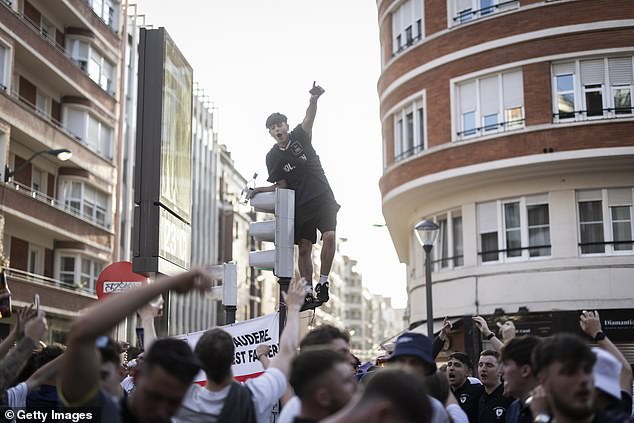 Fans were pictured standing on traffic lights and climbing lamposts in the Spanish city