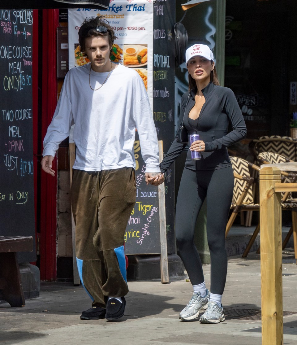 Cruz Beckham and his girlfriend Jackie Apostel holding hands while shopping.