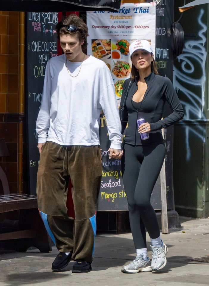 Cruz Beckham and his girlfriend Jackie Apostel holding hands while shopping.